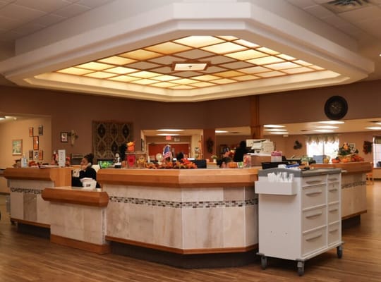 Interior view of a common area with residents and staff