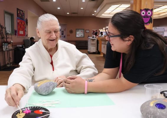 Resident and staff engaging in an arts and crafts activity