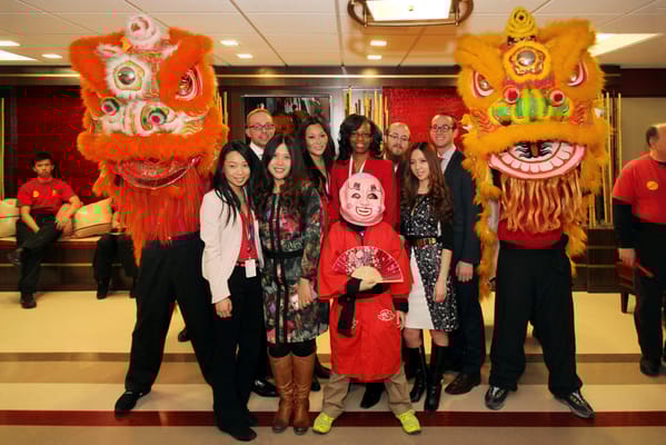 Residents and staff celebrating with lion dancers