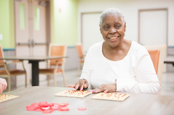 Resident enjoying a bingo game in a common area