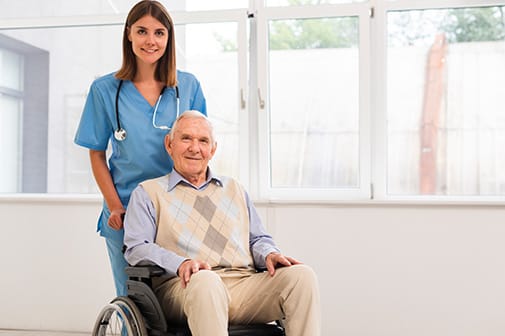 A caregiver and resident in a bright interior space