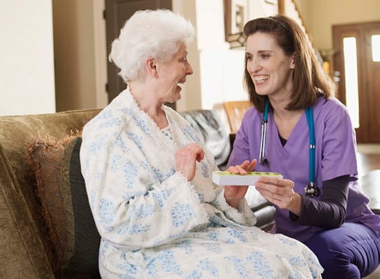 A staff member interacting with a resident in a common area