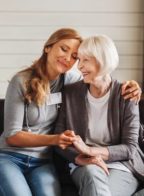 A caregiver and resident sharing a warm moment together