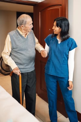 Staff assisting a resident in a hallway