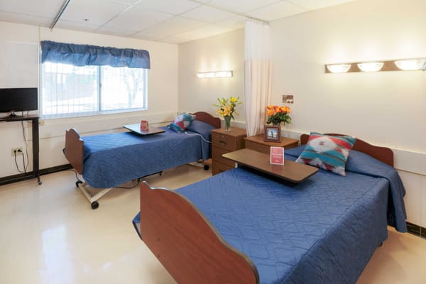 Well-furnished twin resident room in a nursing home
