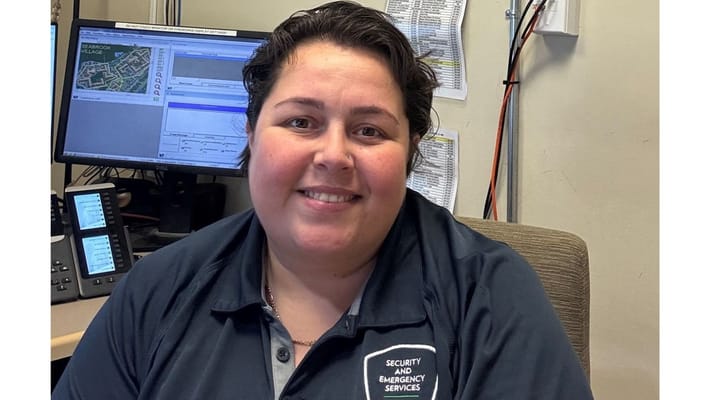 Staff member at a security desk in the facility