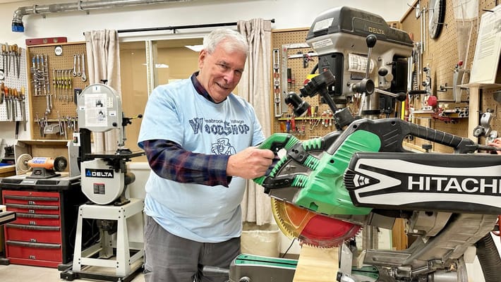 Resident enjoying woodworking activity in a workshop