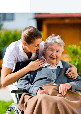 Caring staff assisting a resident in a garden