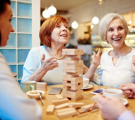 Residents enjoying a game of Jenga in a social setting