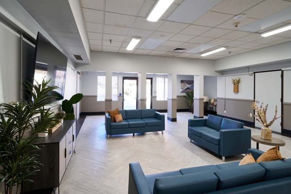 Bright common area with blue seating and decor