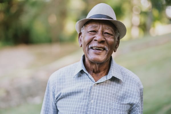 Senior man smiling in a garden setting