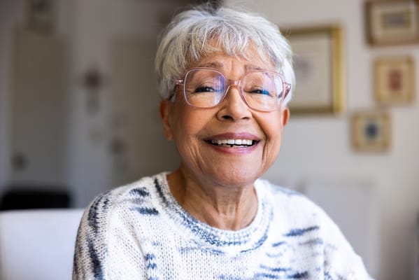 Smiling senior woman wearing glasses indoors