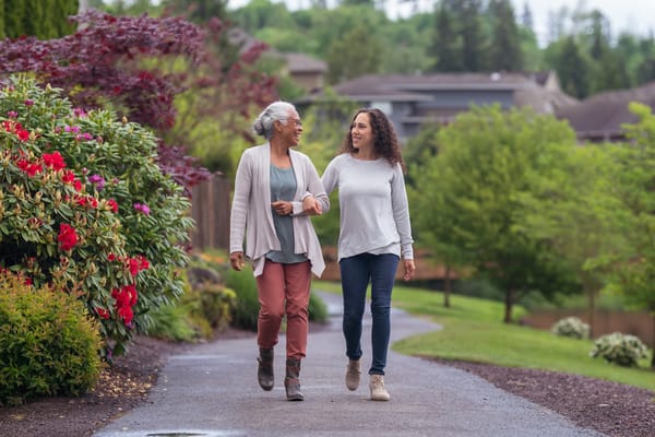 Two women walking in a scenic outdoor path