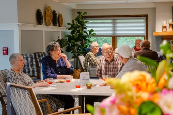 Residents engaging in conversation at a communal table