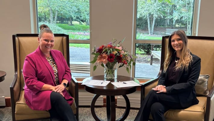 Two staff members seated in a welcoming common area