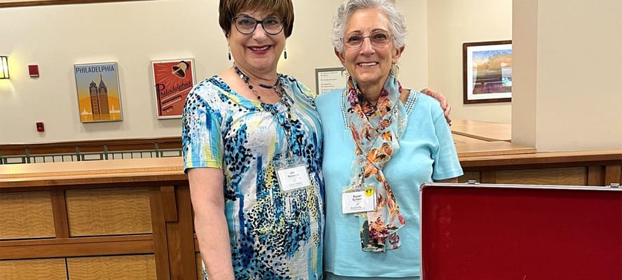 Two women posing in a common area of the facility