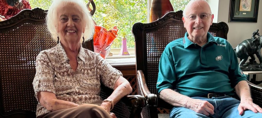 Two residents smiling in a cozy interior setting