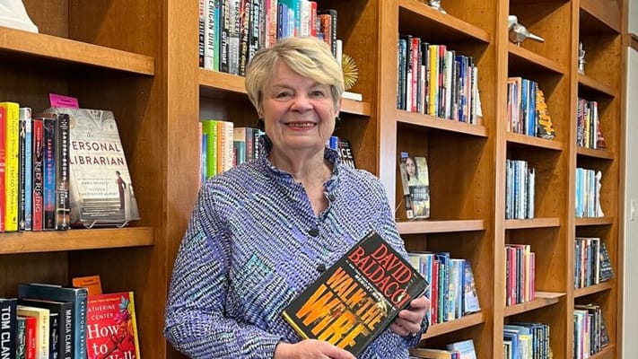 Resident holding a book in a facility library