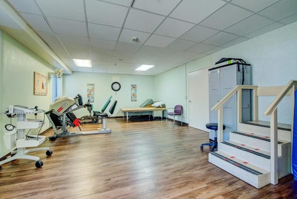 Physical therapy room with exercise equipment
