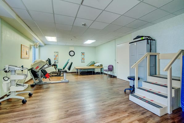 Physical therapy room with exercise equipment