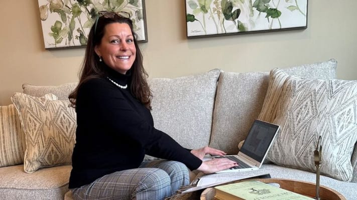 Staff member working in a cozy common area