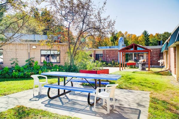 Outdoor picnic area with tables and garden