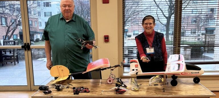 Residents engaging in a model airplane activity indoors