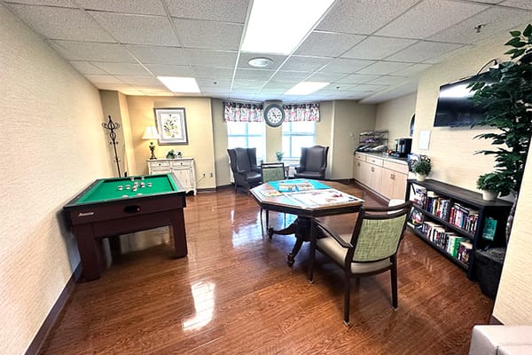 Bright common area with pool table and seating