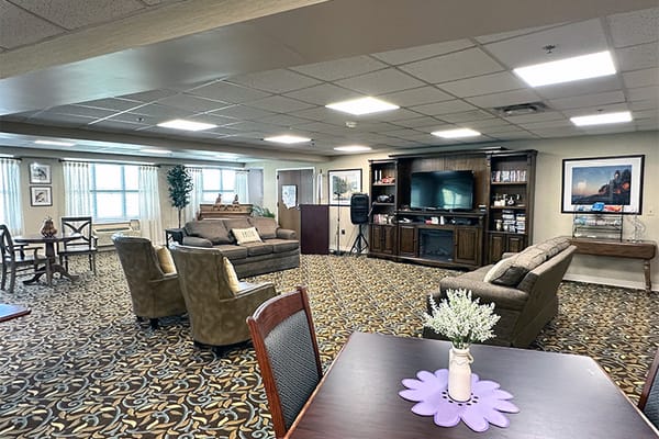 Common area with couches and television in a senior living facility