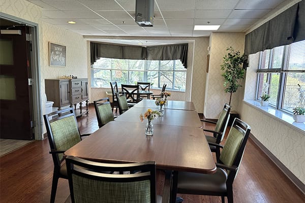 Bright common area with dining tables and flowers