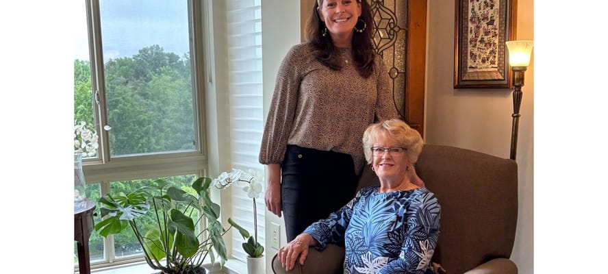 A staff member and resident in a comfortable lounge.