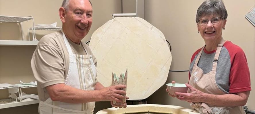 Residents happily engaging in a pottery activity
