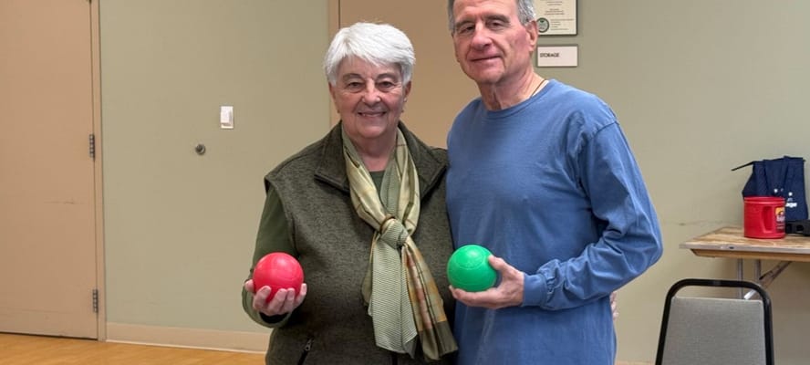 Residents participating in an indoor activity with red and green balls
