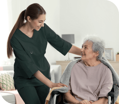 A caregiver interacting with a smiling resident