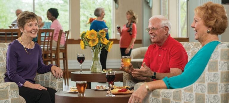 Residents enjoying drinks and conversation in a common area