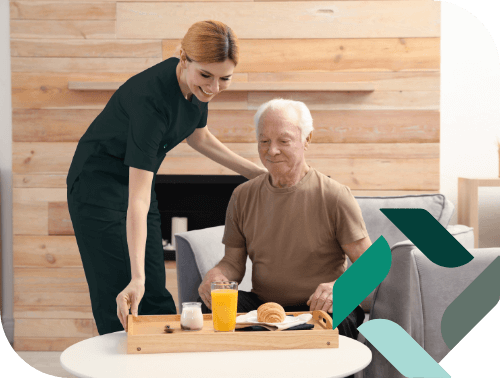 Staff serving a meal to a resident in a cozy setting
