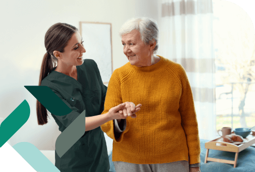 Staff assisting a resident in a cozy interior space