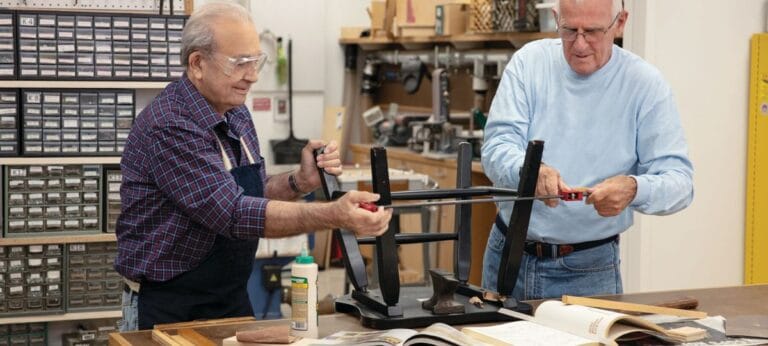 Two residents working on a woodworking project together