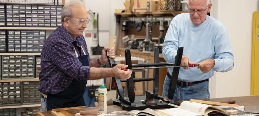 Two residents working on a woodworking project together