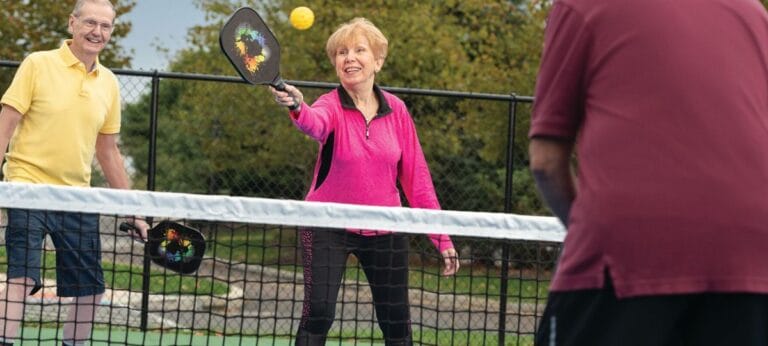 Residents playing pickleball outdoors