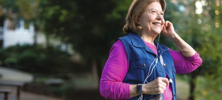 Smiling senior woman enjoying her walk outdoors