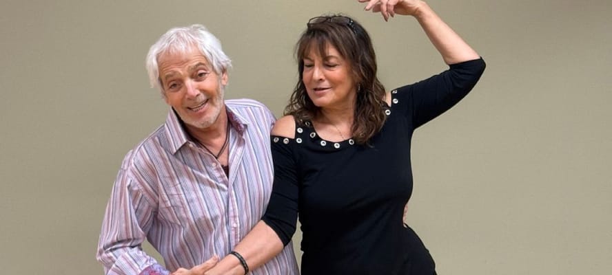 Two residents participating in a lively dance activity