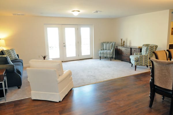 Bright common area with seating and large windows