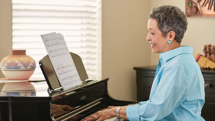 Resident playing piano in a well-lit room