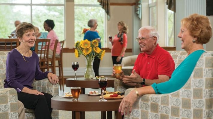 Residents enjoying drinks and snacks in a common area