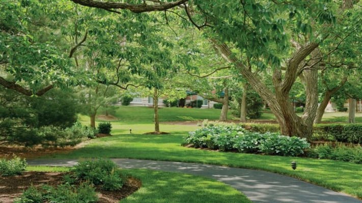 Lush garden with winding pathways at an assisted living facility
