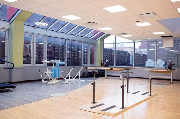 Interior view of a therapy gym with exercise equipment