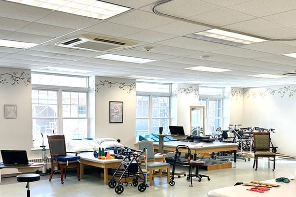 Spacious therapy room with exercise equipment and furniture