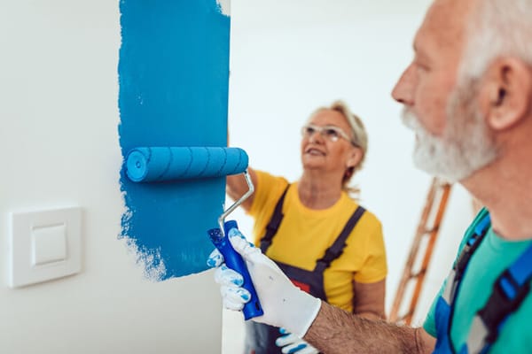 Residents painting a wall together in an activity