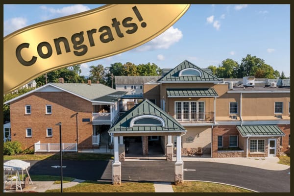 Exterior view of facility with a congratulatory banner